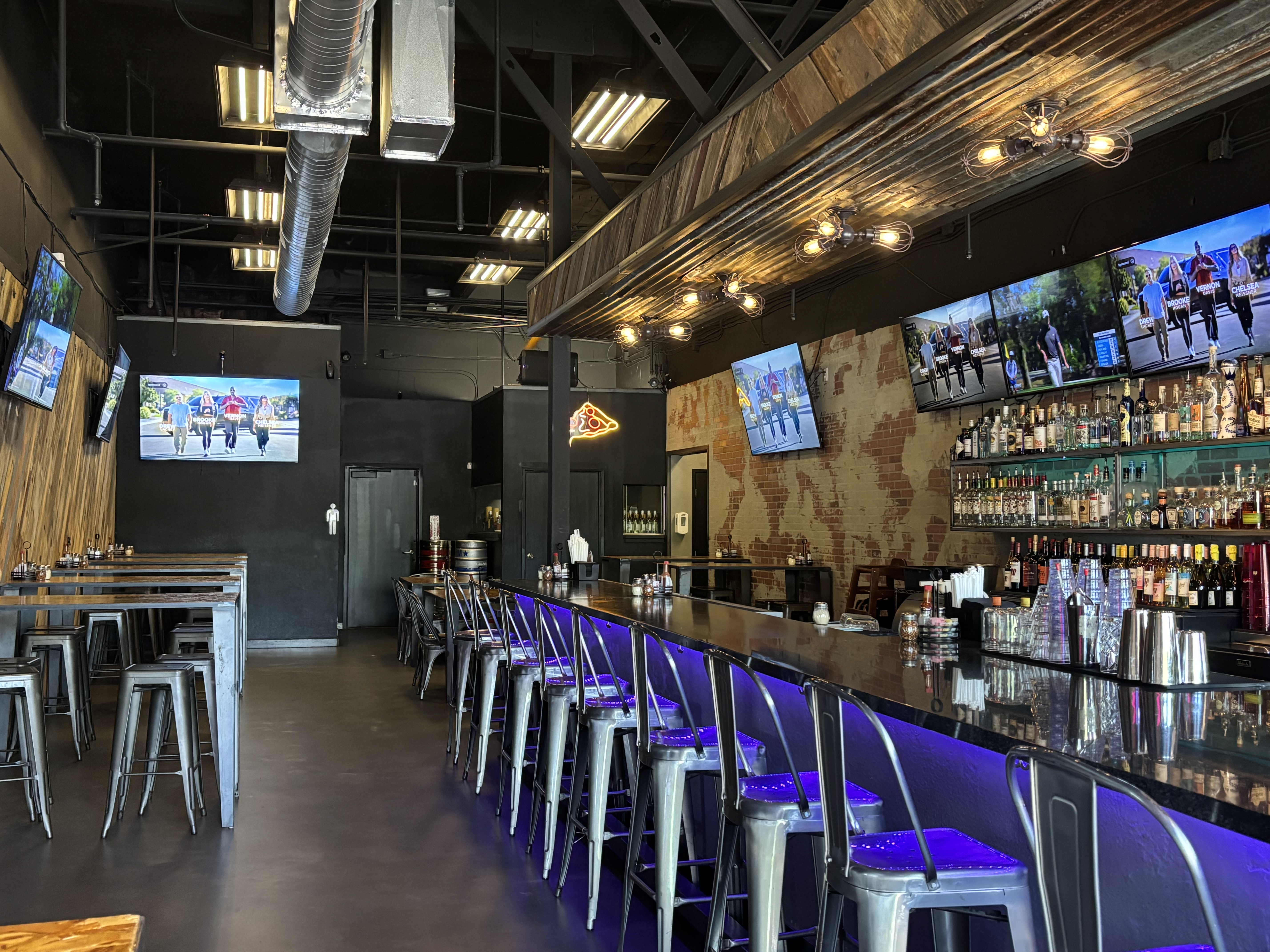 Full bar interior with purple lighting
